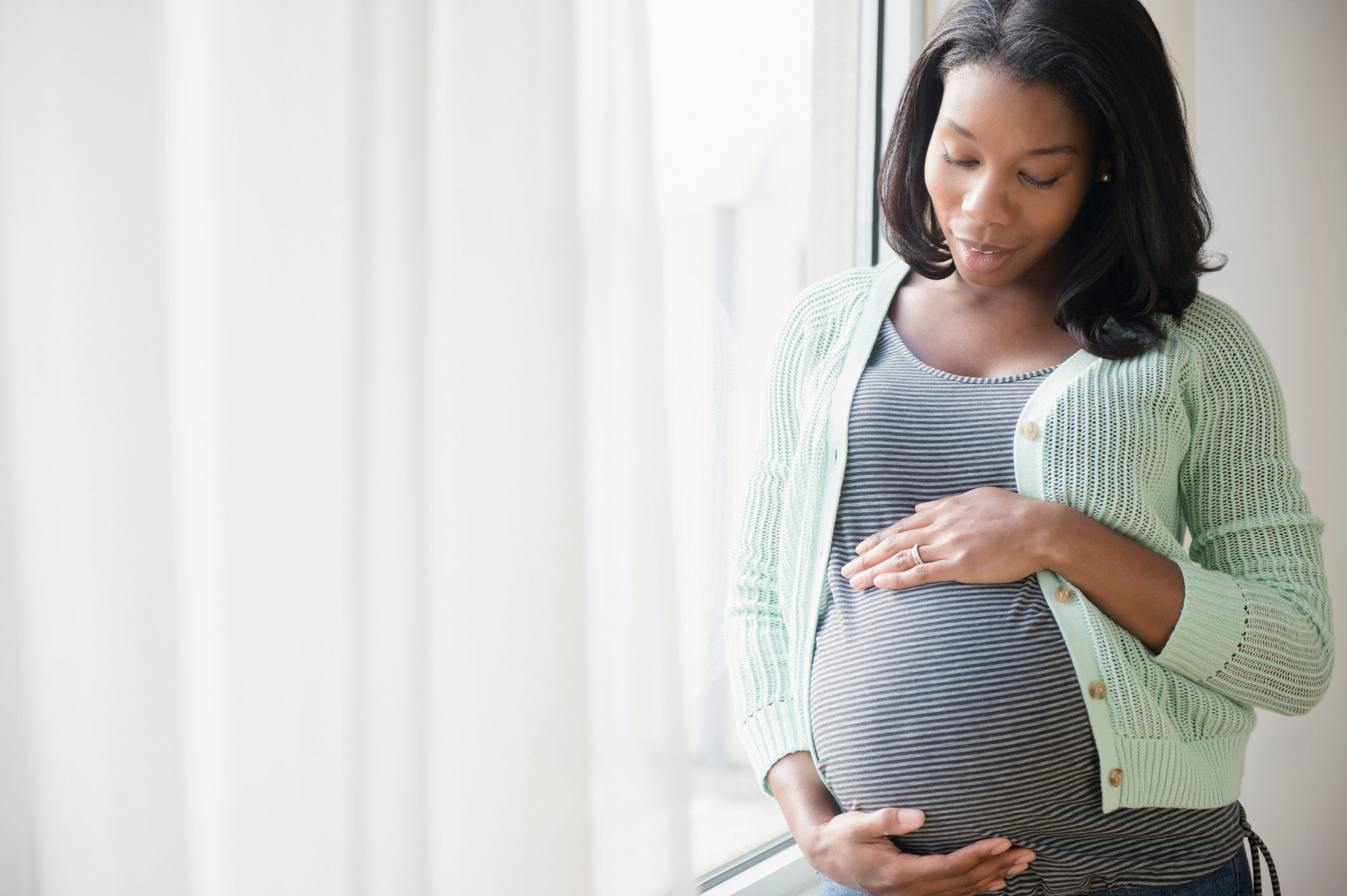 pregnant woman holding belly