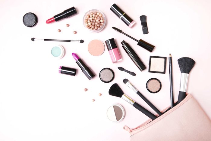 Makeup bag with makeup products spilling out onto a surface.