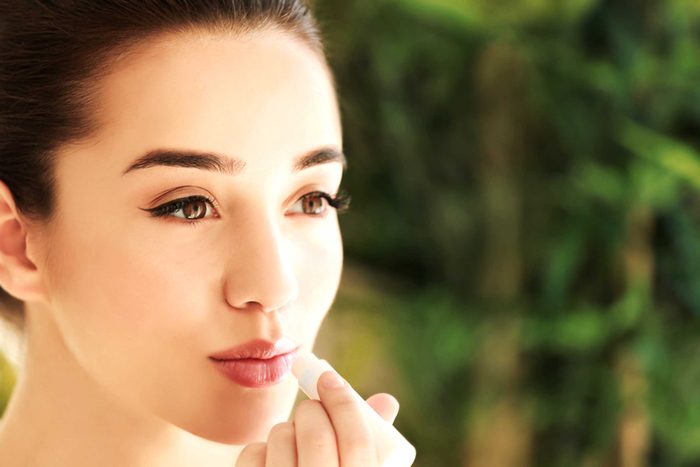 woman applying lip balm