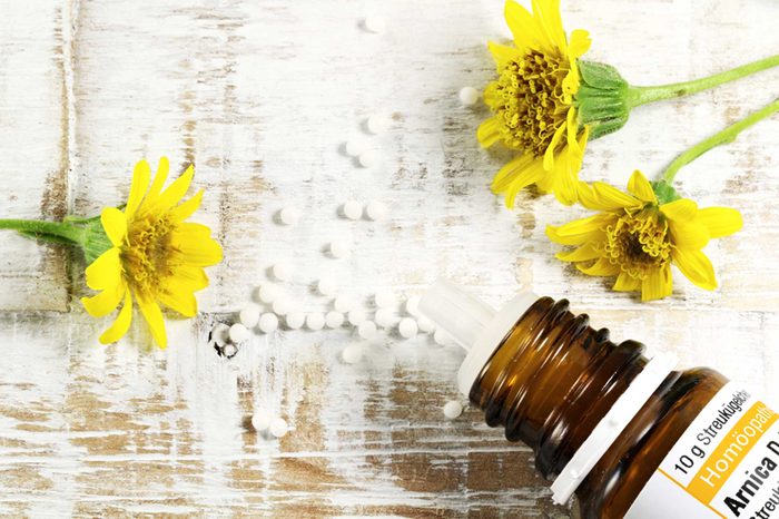 arnica flowers, bottle, and pills