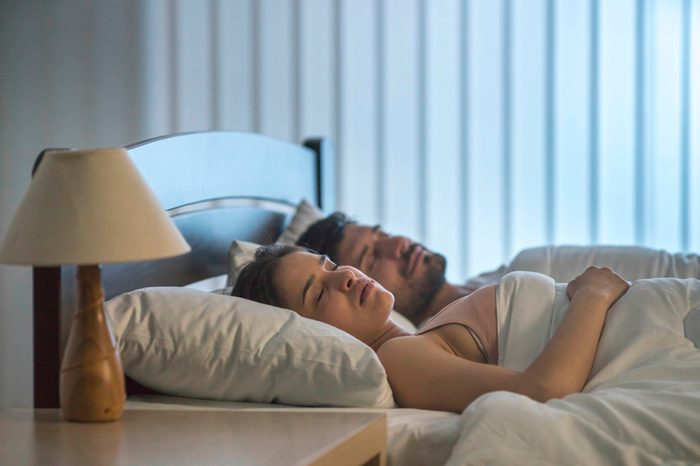 man and woman sleeping in bed