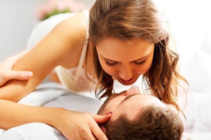 couple in intimate embrace while lying down