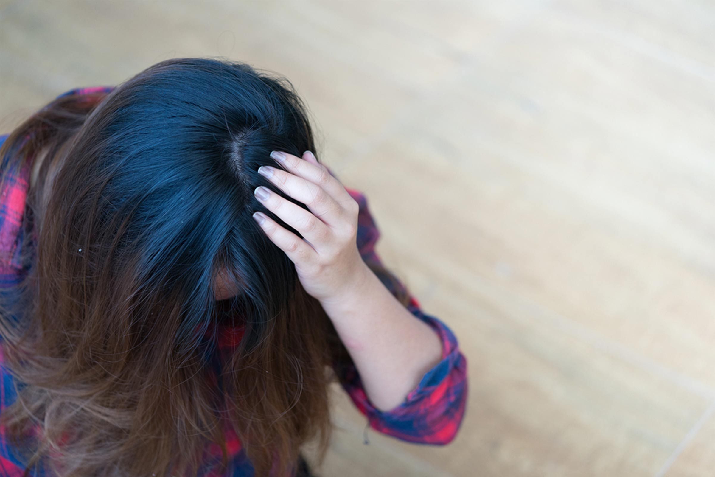 woman scratching at scalp