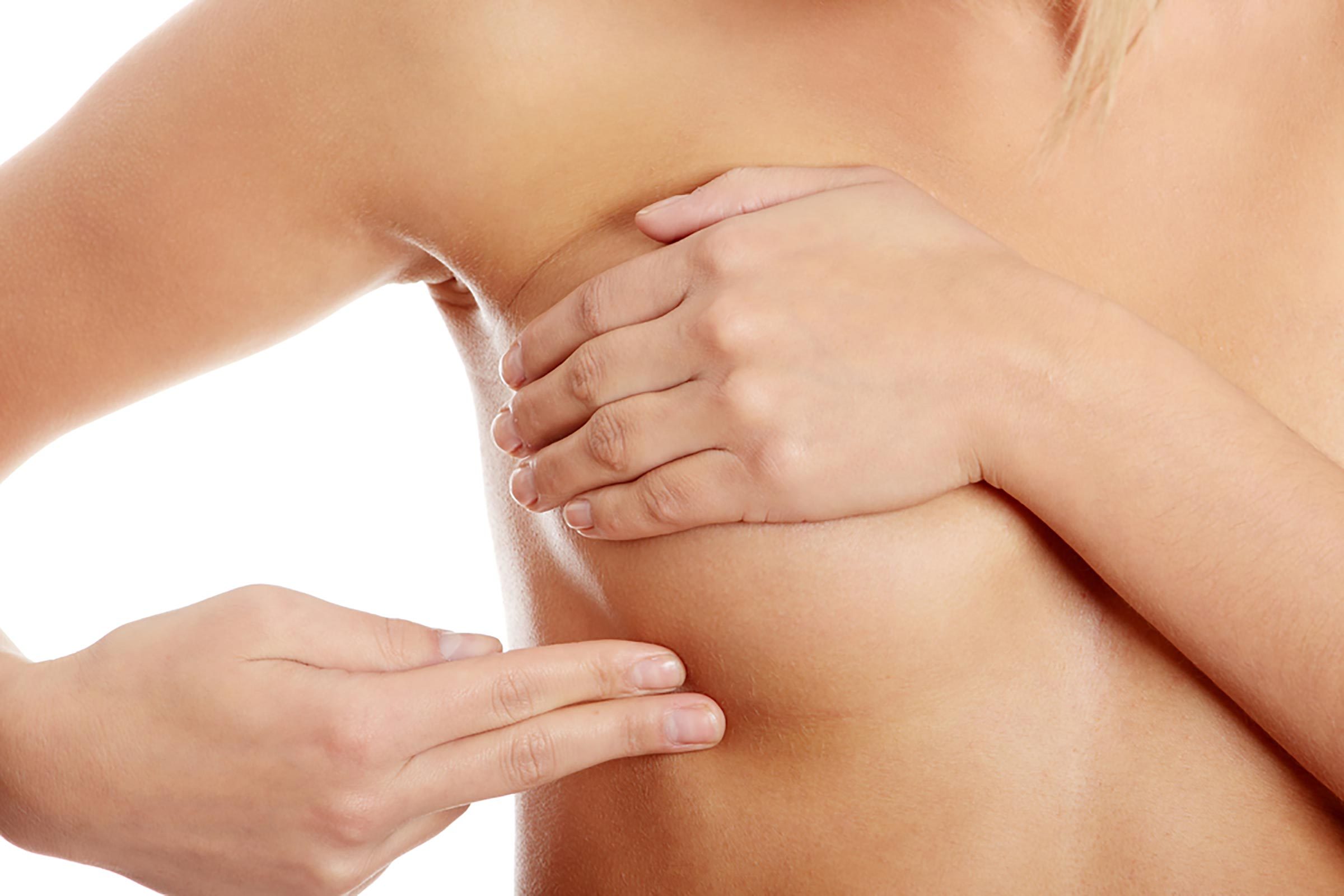 woman examining her breast