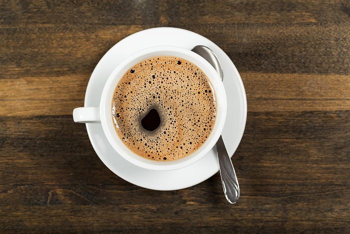 cup of coffee on a walnut table