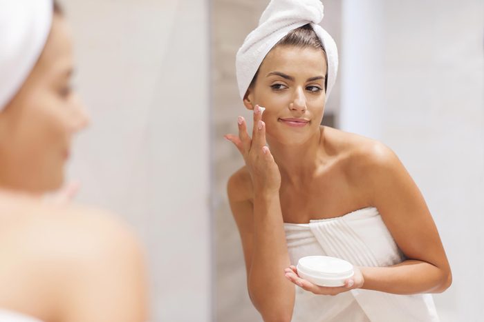 Woman applying face cream