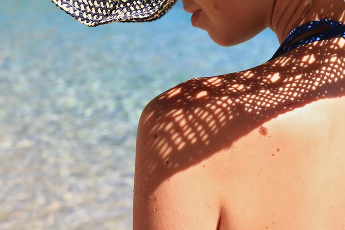 Sun shining on woman's back