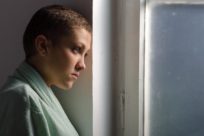 woman with short cropped hair looking gloomy