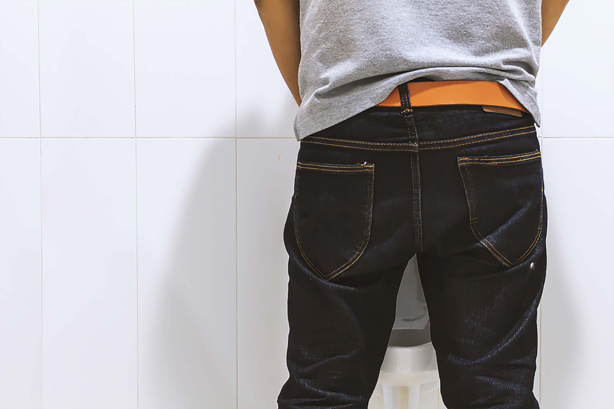 man at urinal