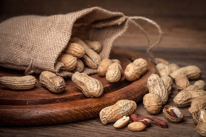 burlap bag full of whole peanuts