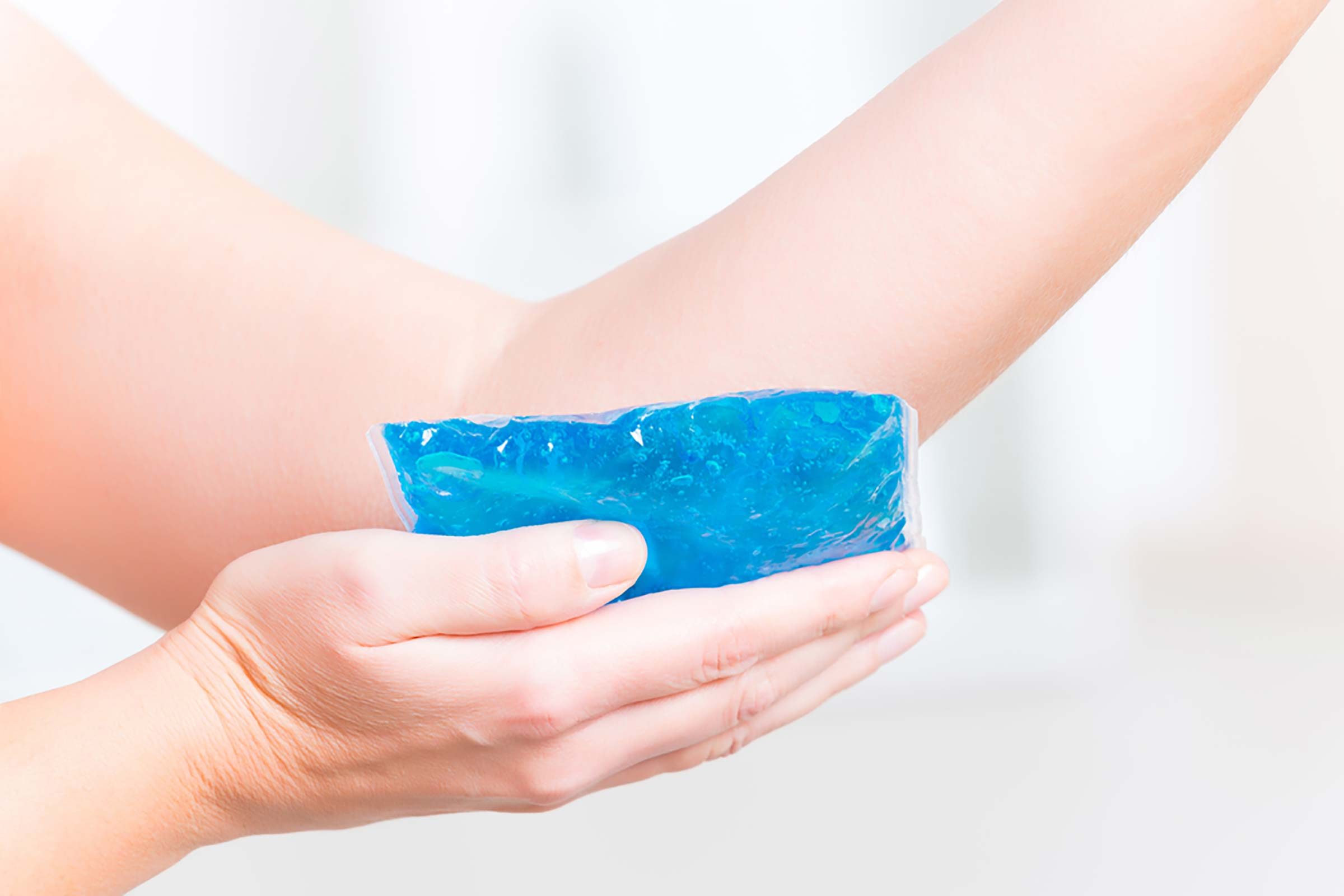 woman applying a Cold compress to her elbow