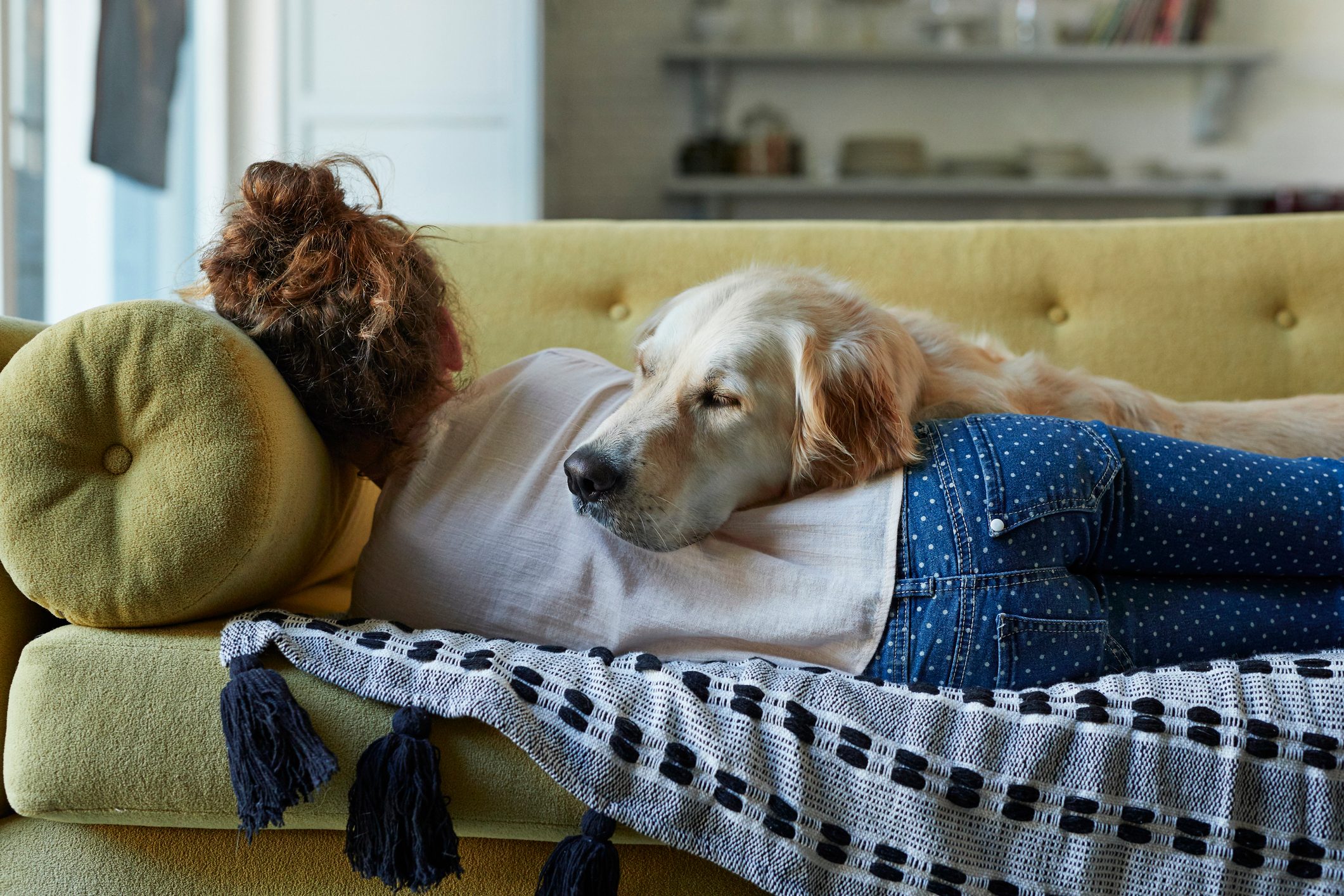 girl sleeping on couch with dog