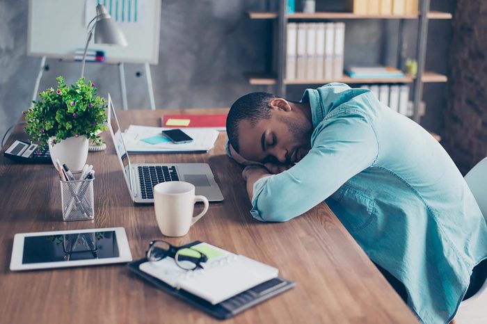 man sleeping on his desk