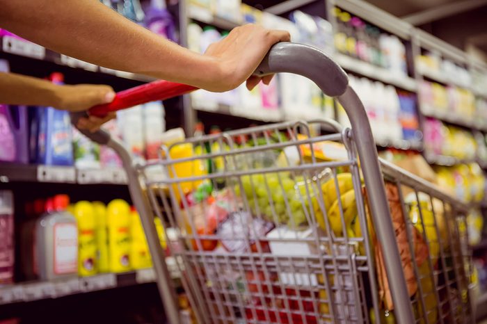 woman pushing shopping cart in grocery store