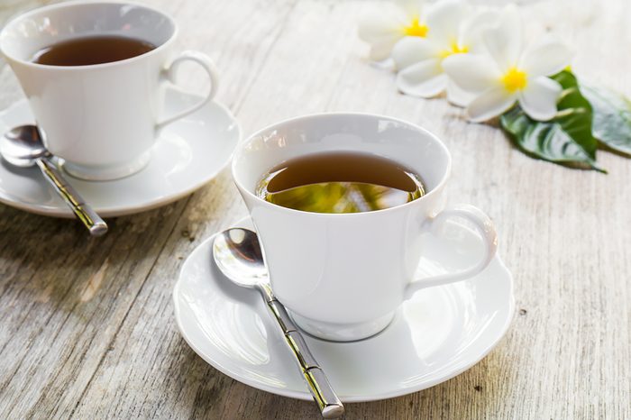 two cups filled with tea on a table