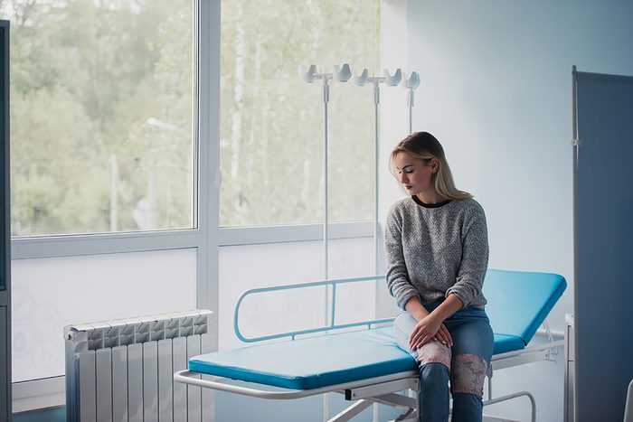 woman sitting on hospital bed