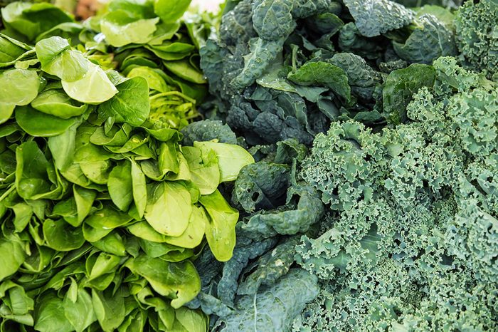 piles of different dark leafy greens, such as kale and chard