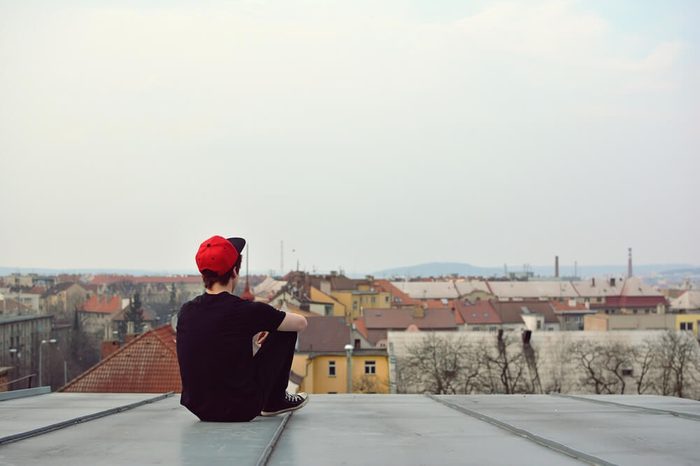 Young guy siting on the roof