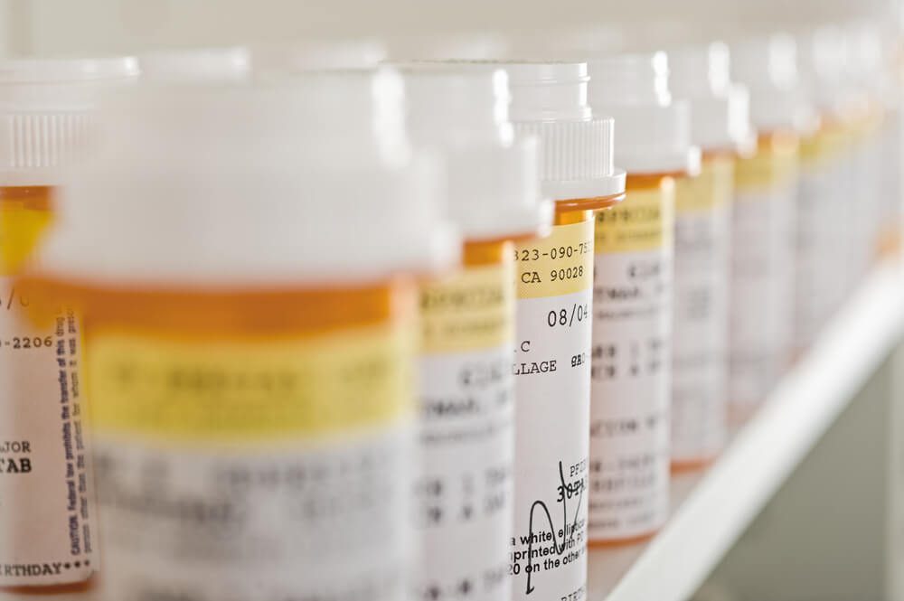 Bottles of pills arranged on shelf at drugstore