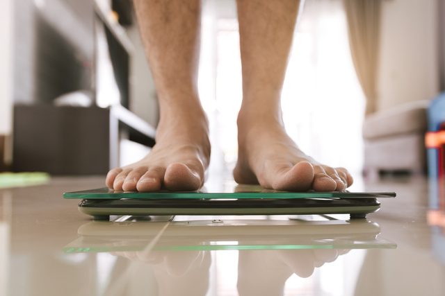 close up of man's feet on scale