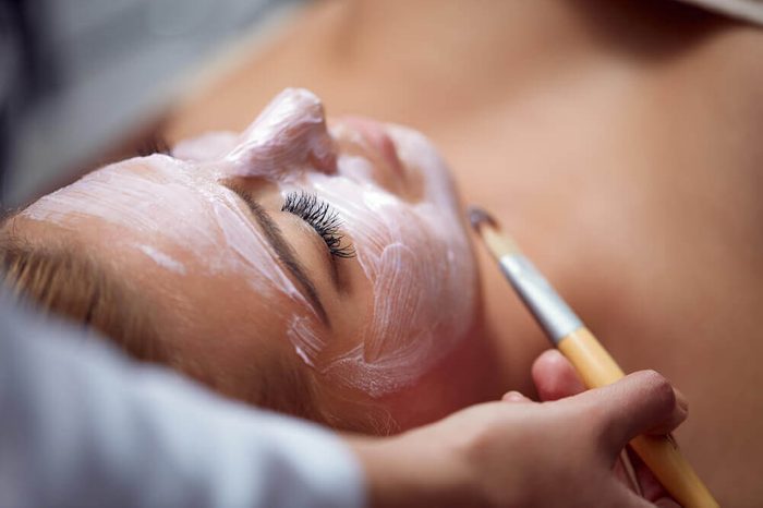Young woman having a facial cosmetic treatment in an aesthetician's office