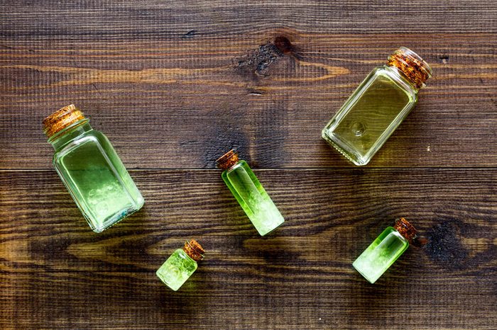 Glass bottles of tea tree oil on a table