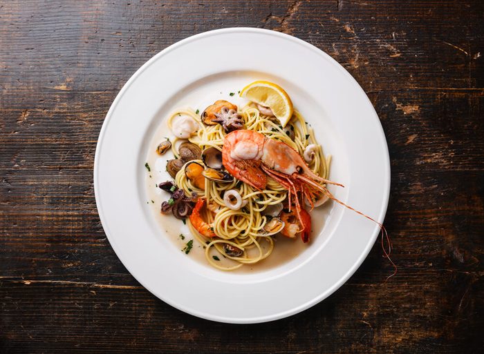 Seafood pasta Spaghetti with Clams, Prawns, Seafood Cocktail on white plate