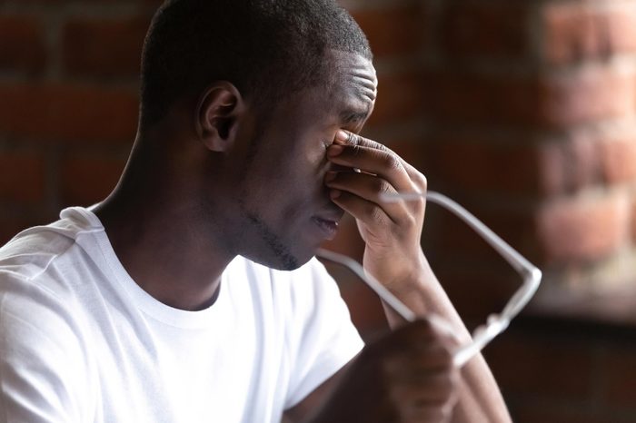 man dry eyes rub