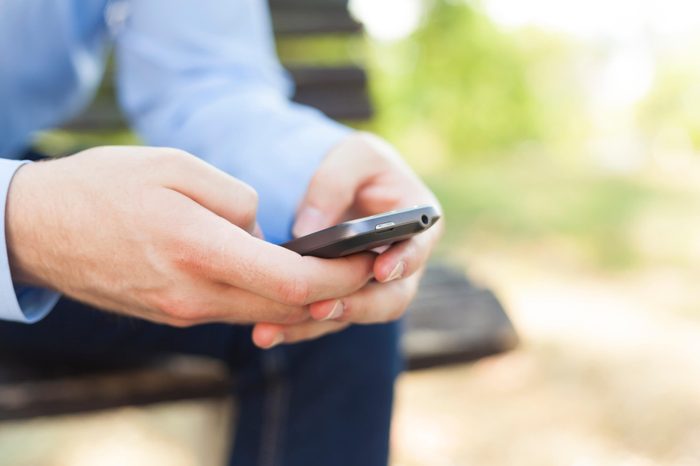 Man texting on smartphone