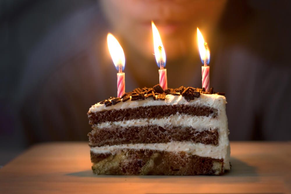 Blow out candles on birthday Cake