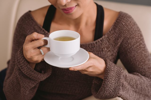 Cropped image of woman drinking tea