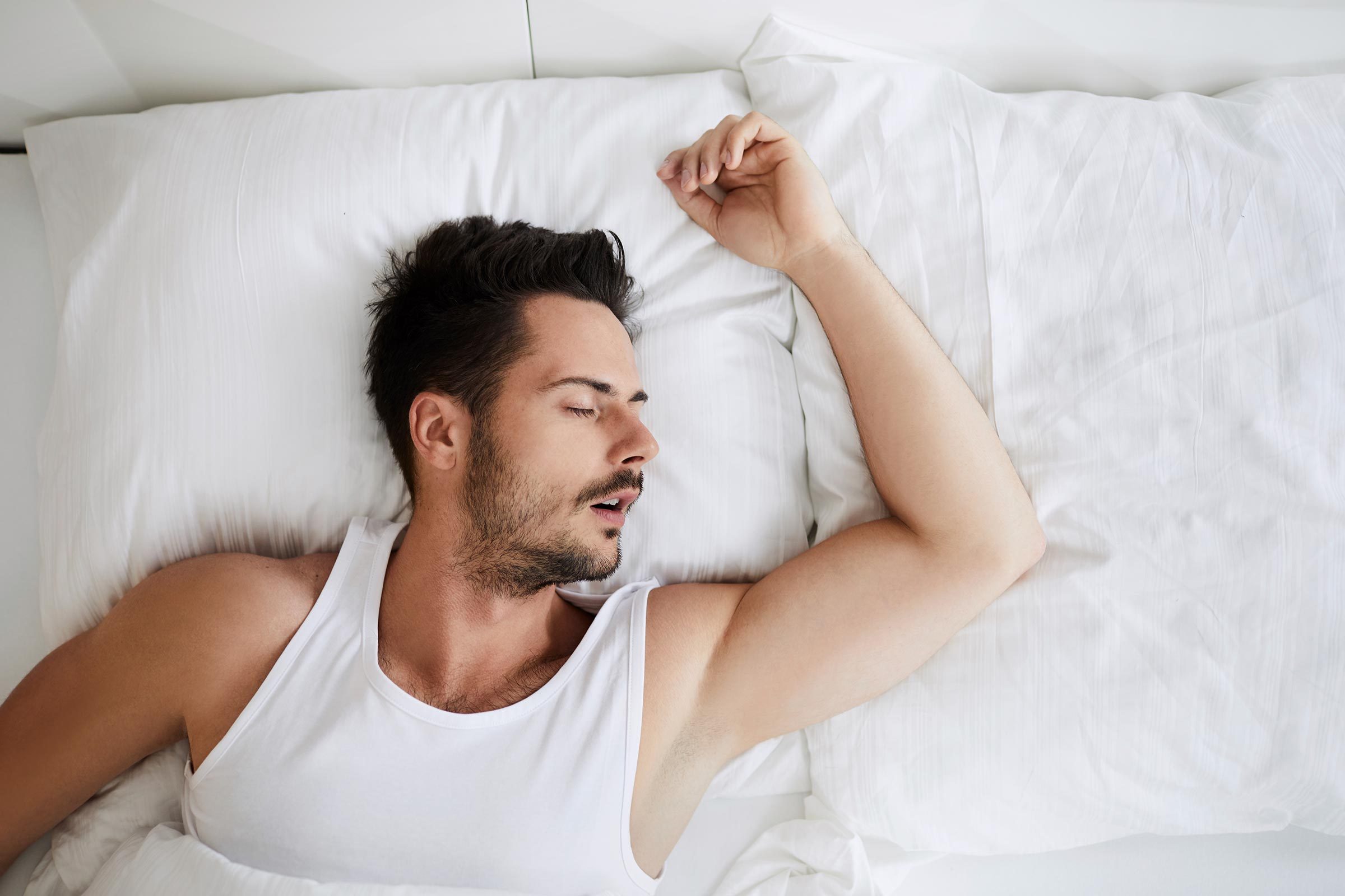 man sleeping on his back, mouth open