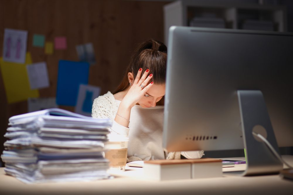 Young and beautiful businesswoman tired from work in the office