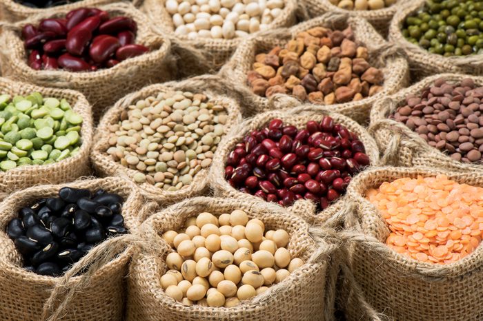 Multicolor dried legumes in burlap sacks