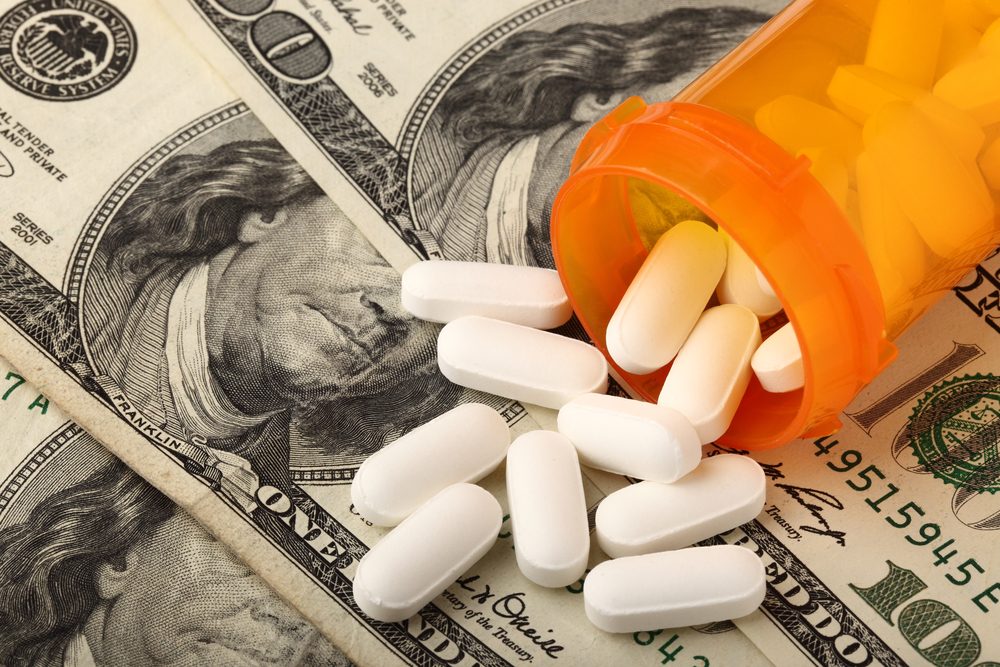 money and Rx container with pills