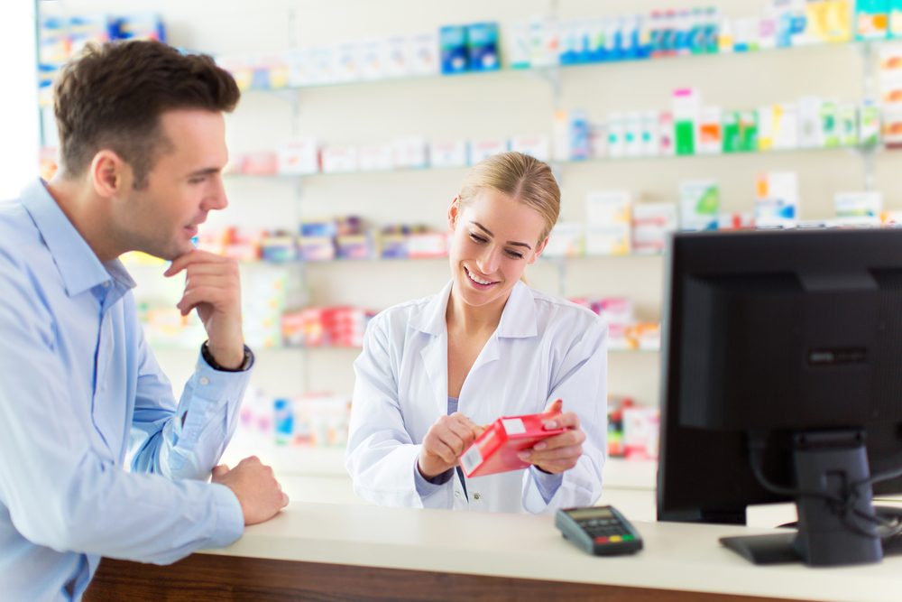patient talking to pharmacist looking at Rx bottle