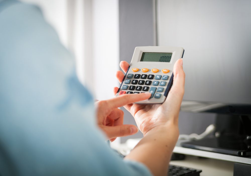 person using a handheld calculator