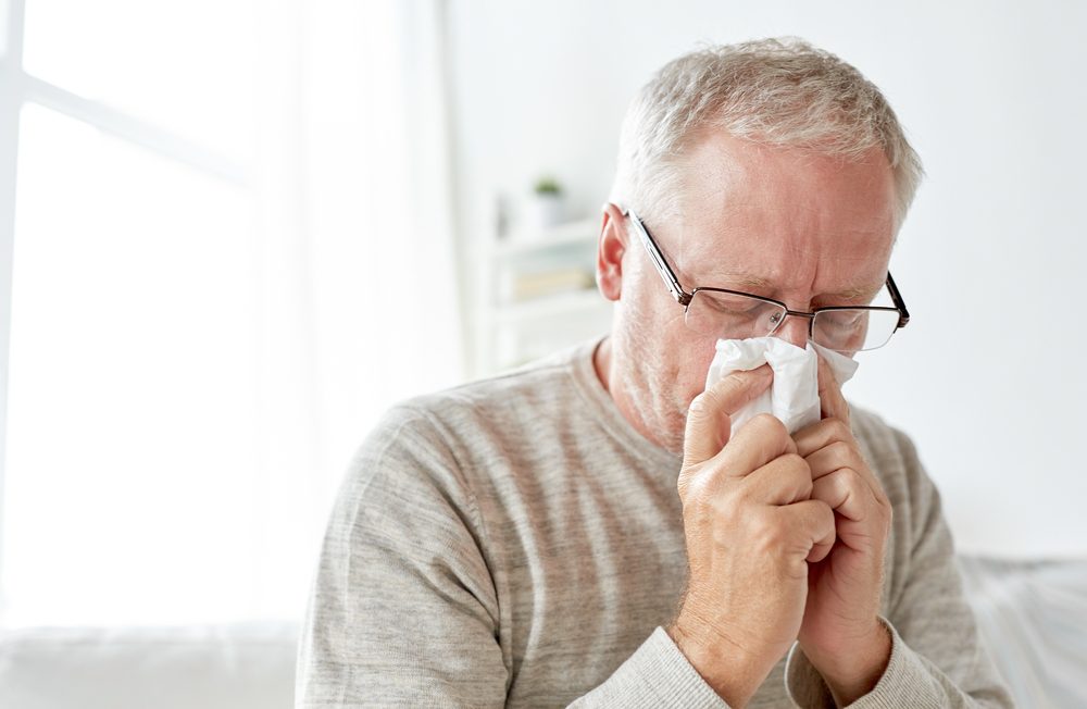 man blowing his nose