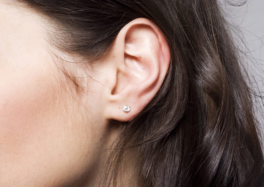 Young pretty woman ear closeup
