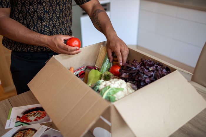 man opening meal kit package