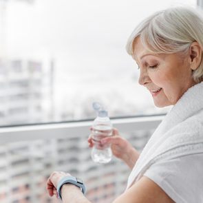 Senior woman using smartwatch after training