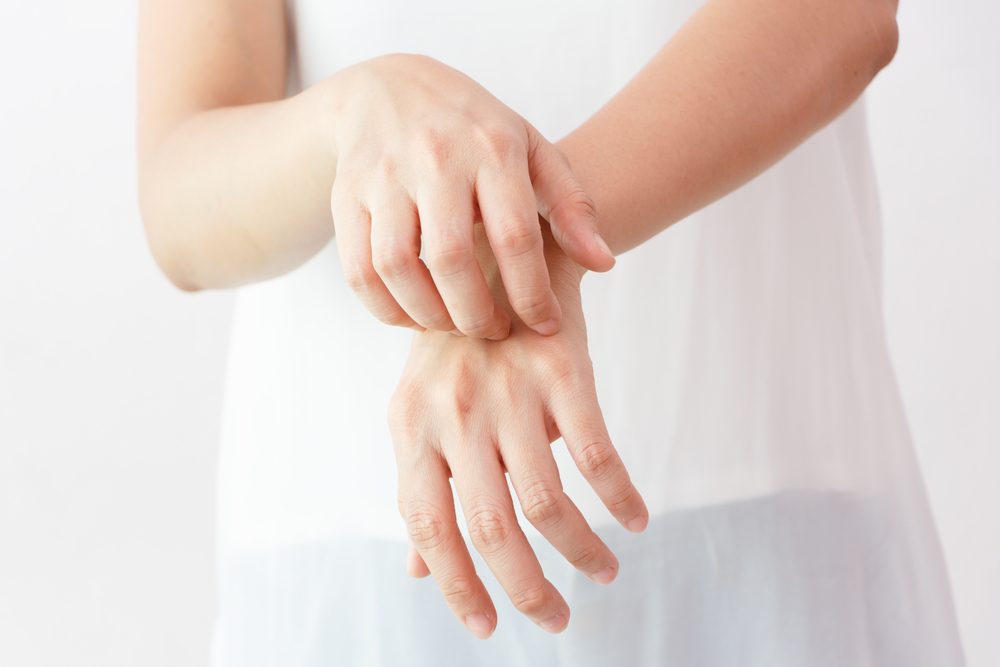 Women scratch the itch with hand / arm  itching / Concept with Healthcare And Medicine.