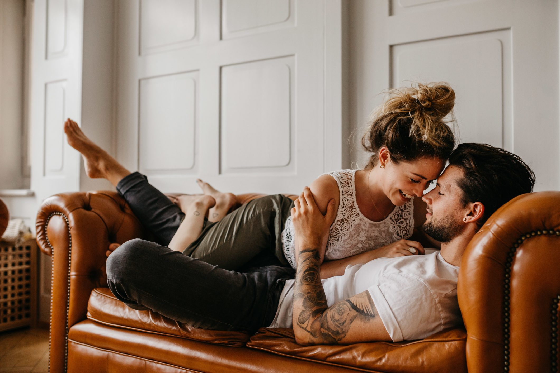 romantic couple on couch at home