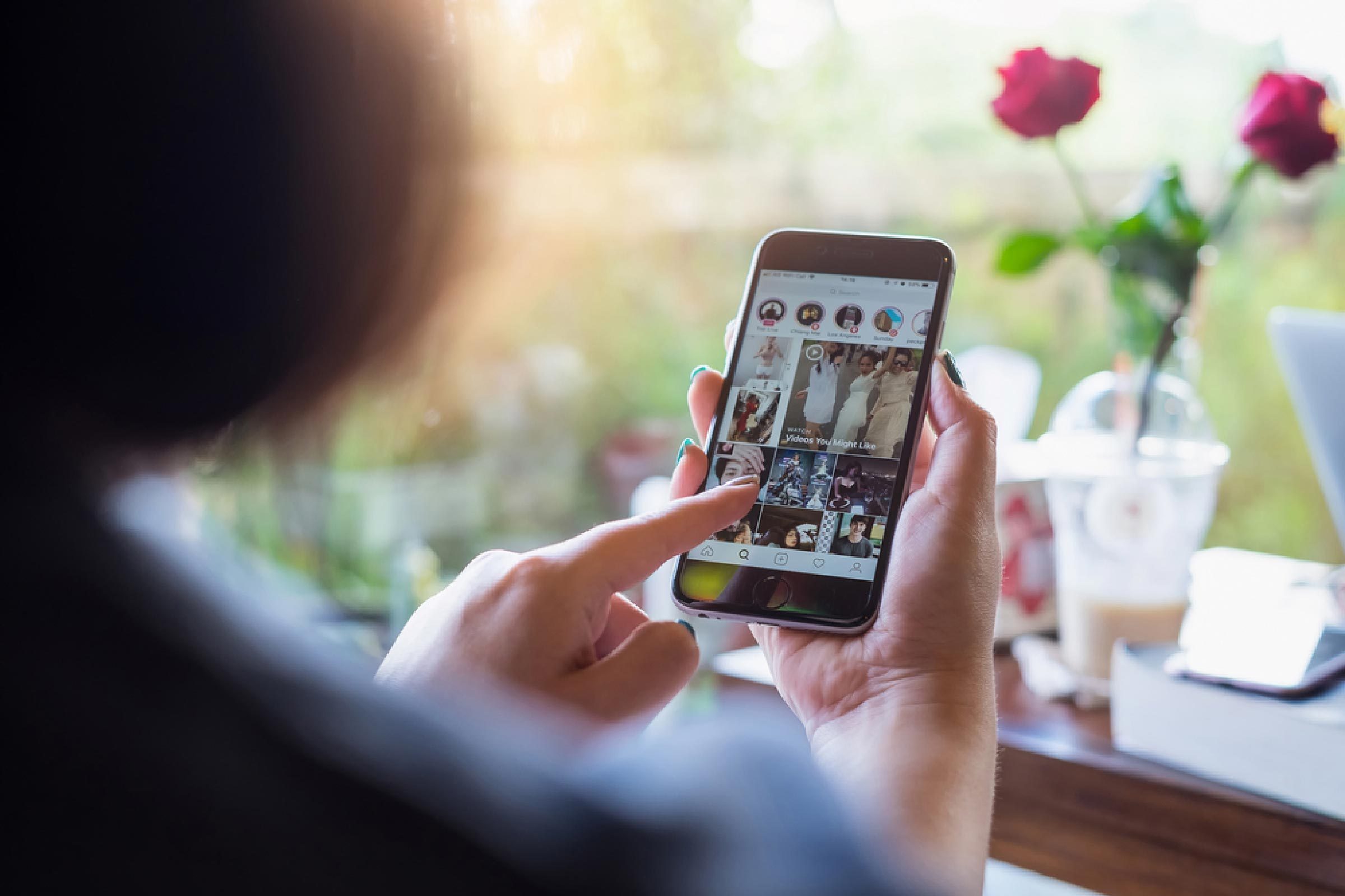 A woman hand holding iphone with login screen of instagram application. Instagram is largest and most popular photograph social networking.