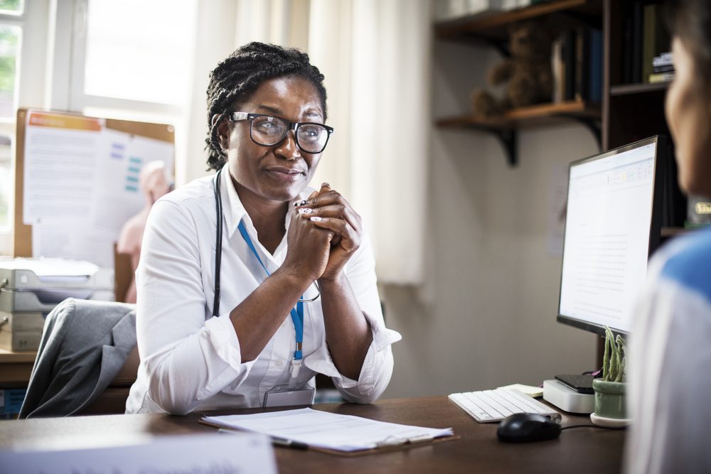 Doctor in her office meeting with a patient