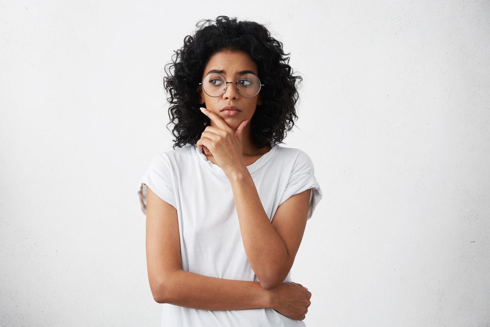 woman with doubtful expression, looking away