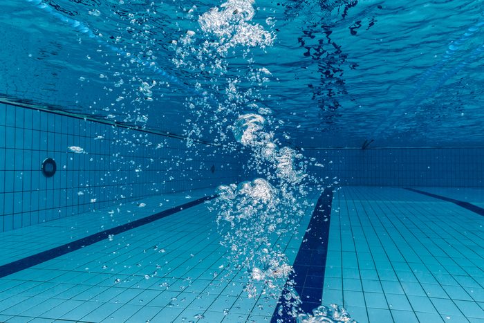 Air bubbles in clear blue water in pool