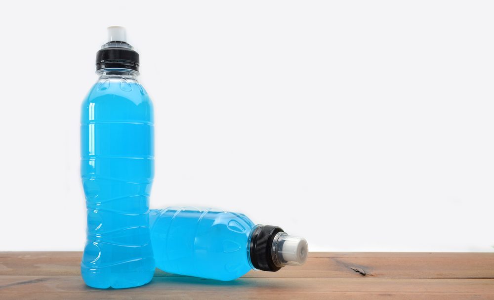 sports drink on wooden table and white background
