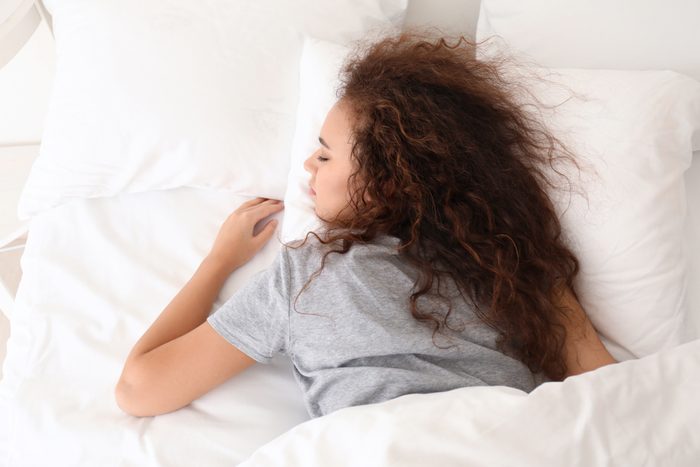 Young woman sleeping in bed.