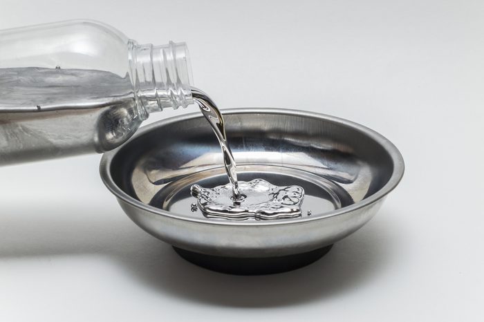 Pouring elemental mercury in a steel bowl